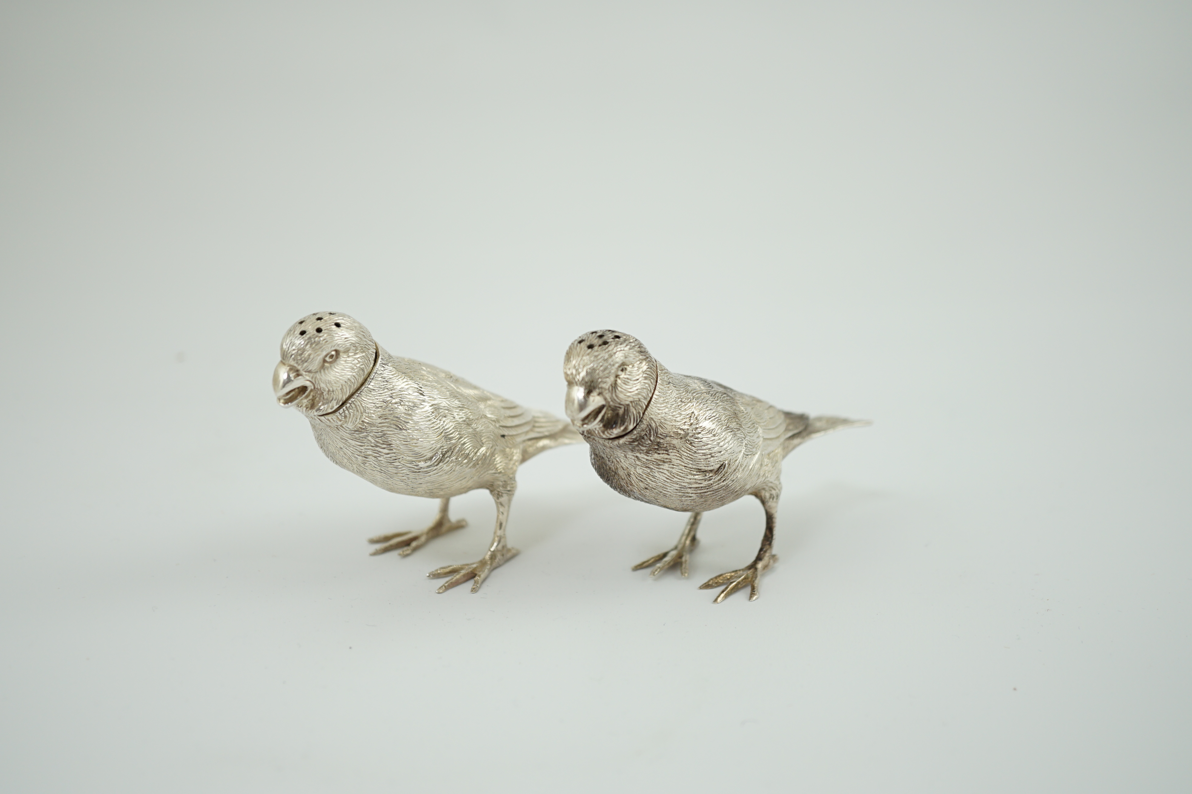 A pair of Elizabeth II silver novelty free-standing pepperettes, modelled as sparrows, by Israel Freeman & Son Ltd